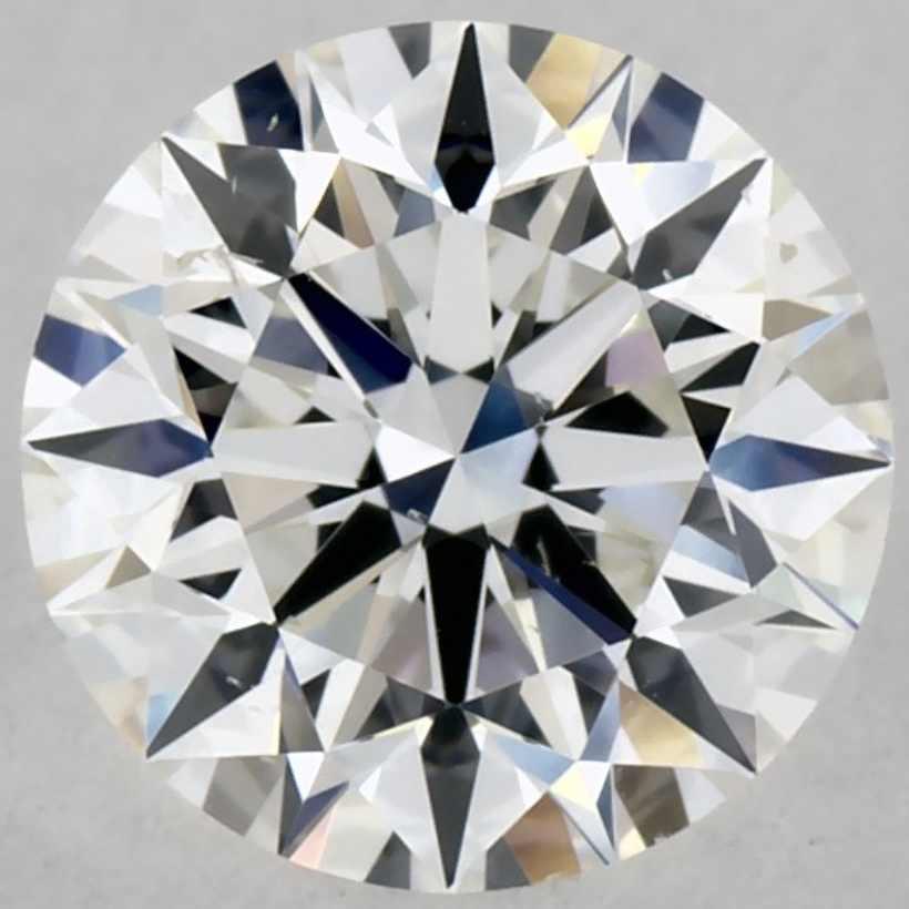 This round SI1 diamond looks clean because its shape hides the inclusions Round cut SI1 diamond with white feather inclusions near the edges, H color, showing a clean face-up appearance.