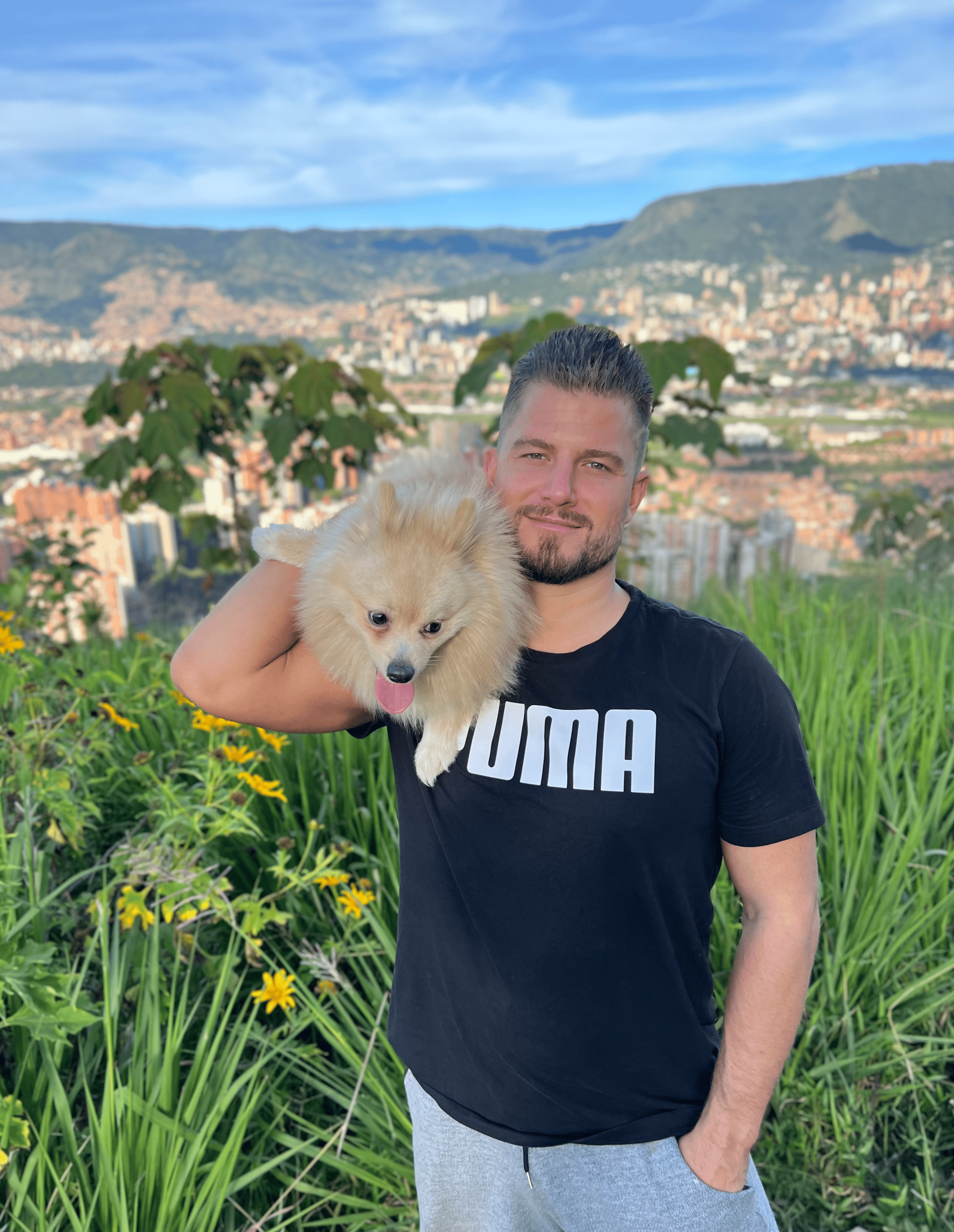 Me and Odin on one of our favorite hikes in Medellín Sebastian Naturski hiking with his Pomeranian Odin overlooking Medellín